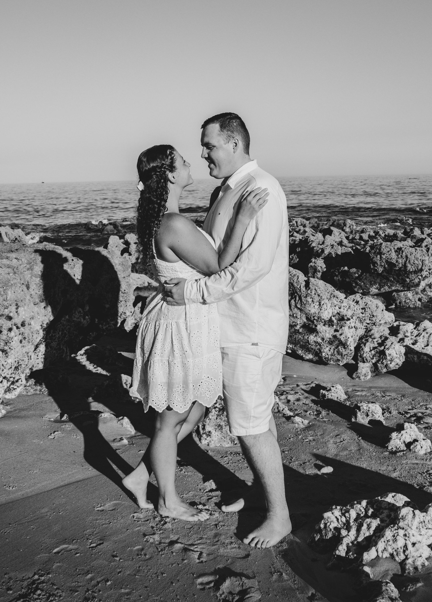 Black and white engagement photoshoot on the rocks, Algarve